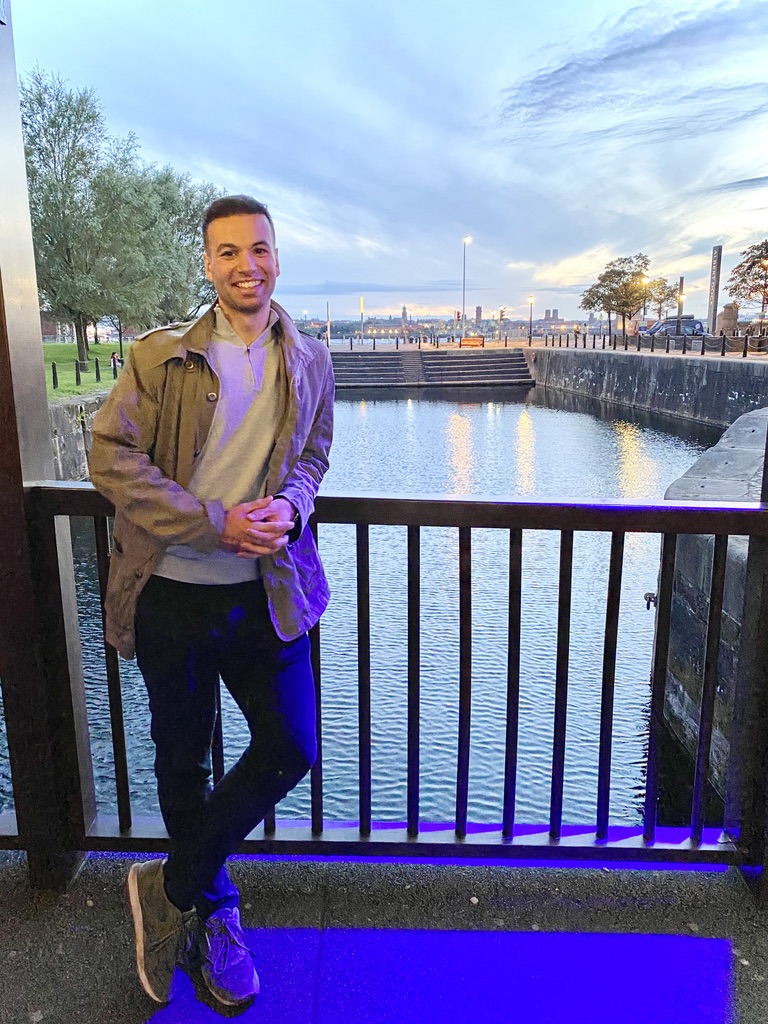 a picture of Giuliano standing on a bridge over a river